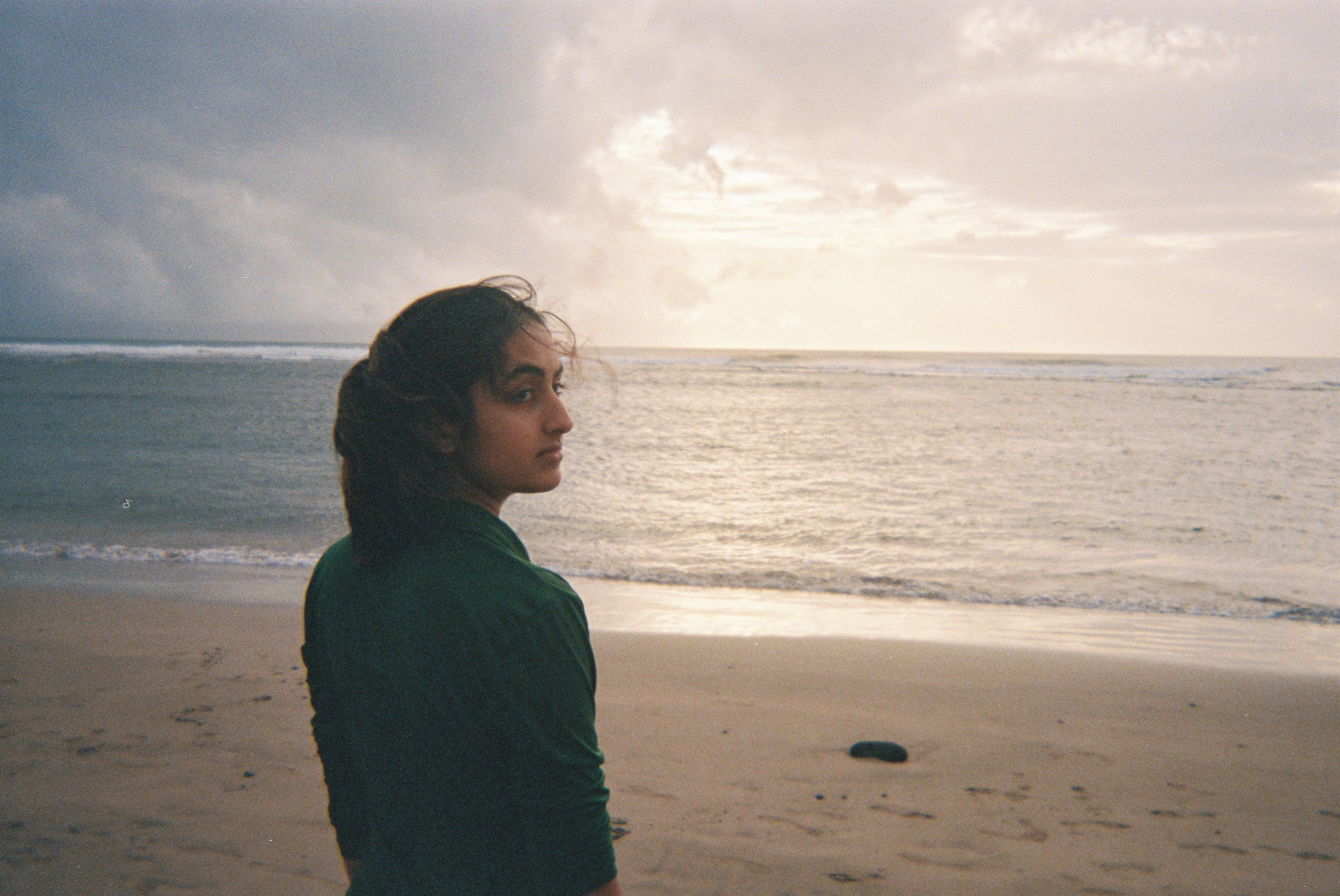 Keya staring out at the ocean in Maui, after a long day of reporting